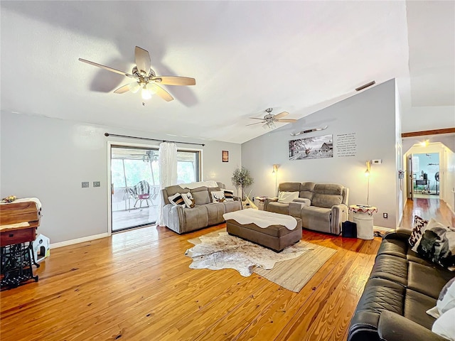 living room with light wood-type flooring and vaulted ceiling