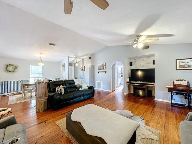 living room with wood-type flooring and lofted ceiling