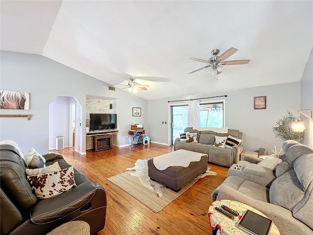 living room with ceiling fan, light hardwood / wood-style floors, and lofted ceiling