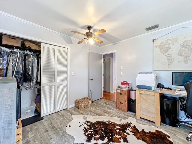 home office featuring ceiling fan, light wood-type flooring, and crown molding