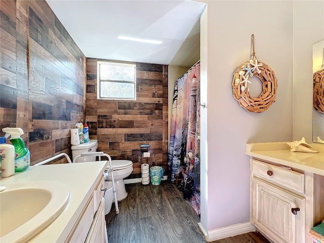 bathroom with wood walls, vanity, wood-type flooring, and toilet