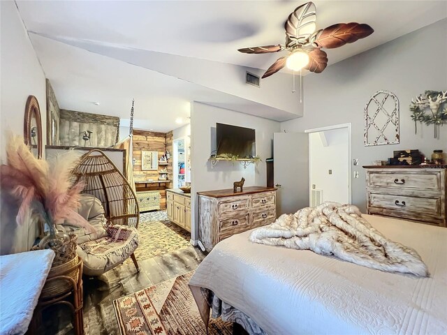 bedroom featuring hardwood / wood-style floors, vaulted ceiling, and ceiling fan