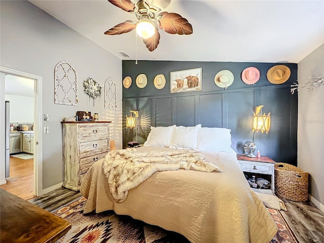 bedroom with hardwood / wood-style floors and ceiling fan