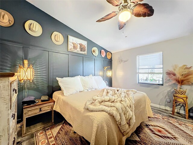 bedroom featuring hardwood / wood-style floors, ceiling fan, and lofted ceiling