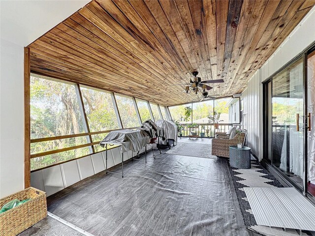 unfurnished sunroom featuring ceiling fan, plenty of natural light, and wood ceiling