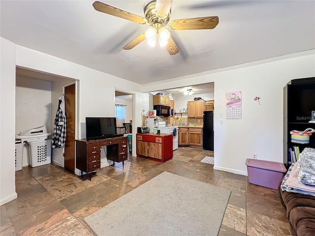 kitchen featuring a center island, ceiling fan, and black appliances