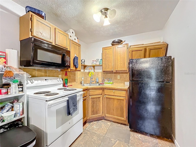 kitchen featuring black appliances, tasteful backsplash, sink, and a textured ceiling