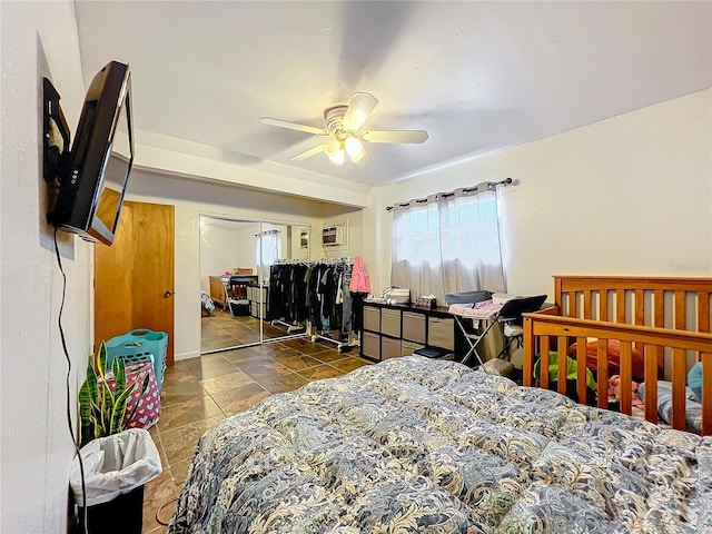 bedroom with a wall mounted AC, a closet, and ceiling fan