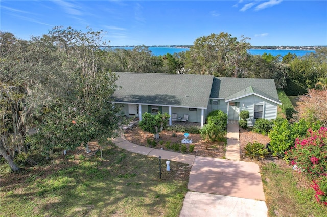 ranch-style home featuring a front lawn and a water view