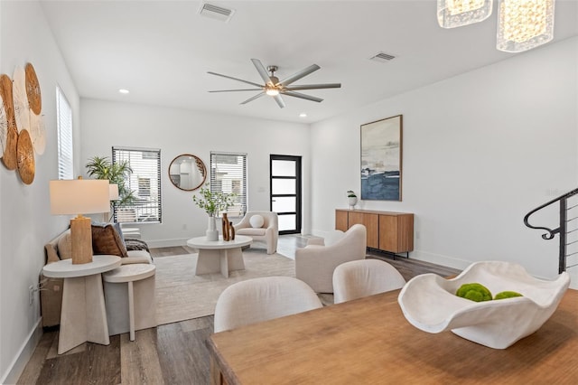 dining area with hardwood / wood-style floors and ceiling fan