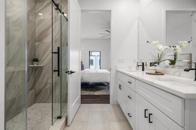 bathroom featuring tile patterned floors, ceiling fan, vanity, and an enclosed shower