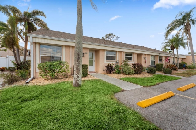 ranch-style home with a front lawn