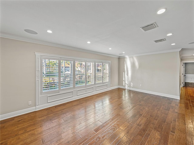 empty room featuring dark hardwood / wood-style flooring and crown molding