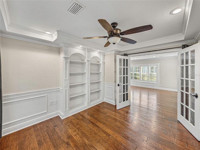 empty room with hardwood / wood-style flooring, ceiling fan, ornamental molding, and french doors