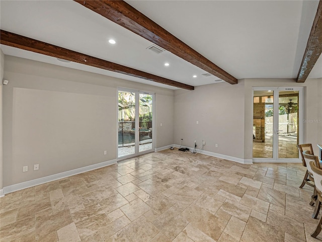 unfurnished living room with beamed ceiling