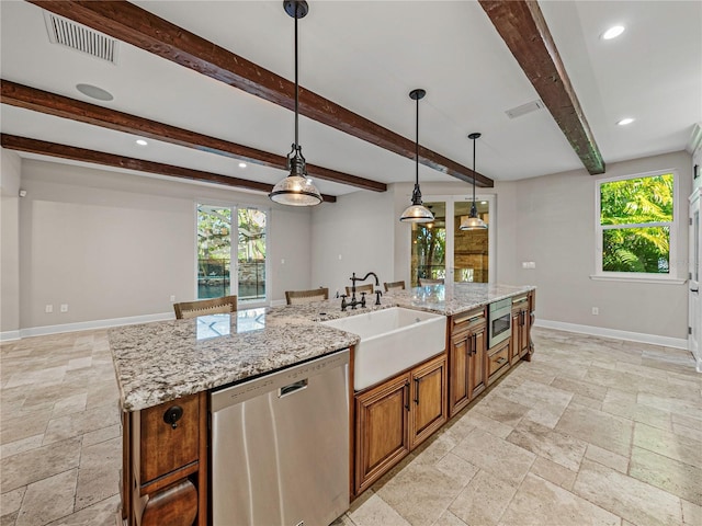 kitchen with appliances with stainless steel finishes, beam ceiling, a large island, and sink