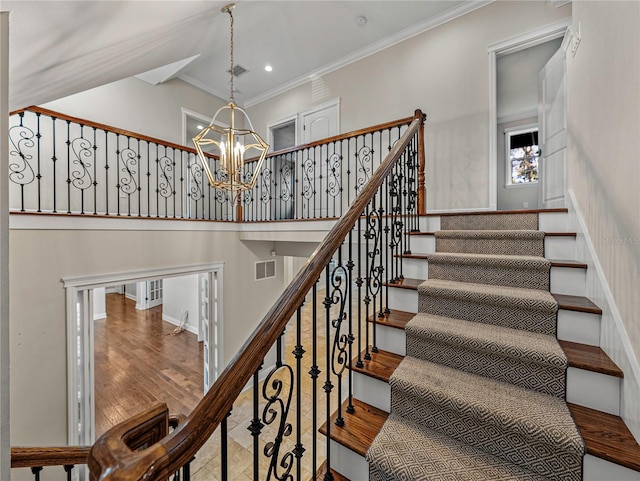 stairs featuring ornamental molding and a notable chandelier