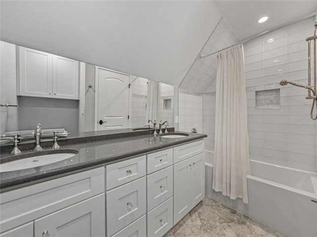 bathroom with shower / bath combo, vanity, and vaulted ceiling