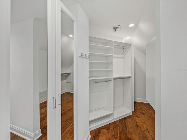 walk in closet with hardwood / wood-style floors