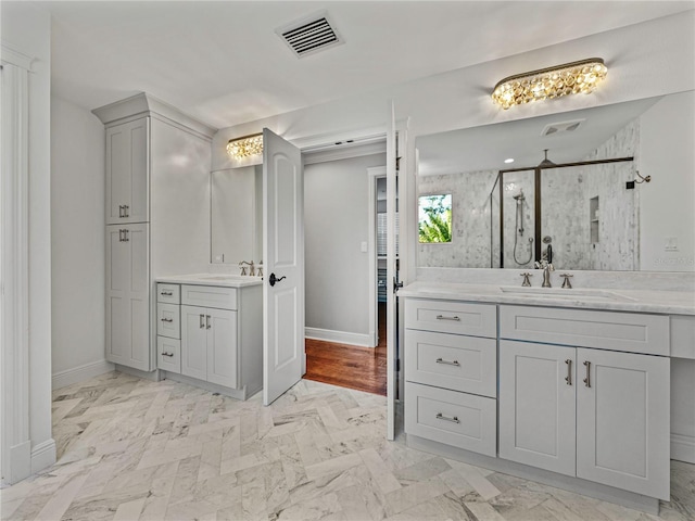 bathroom with vanity and a shower with shower door