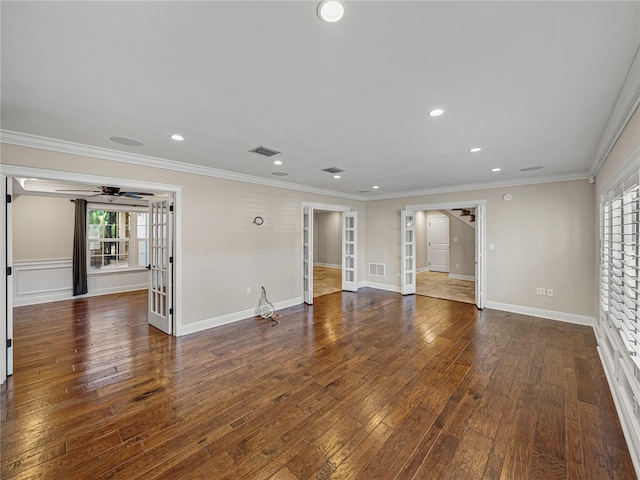 empty room featuring french doors, dark wood-type flooring, and ornamental molding