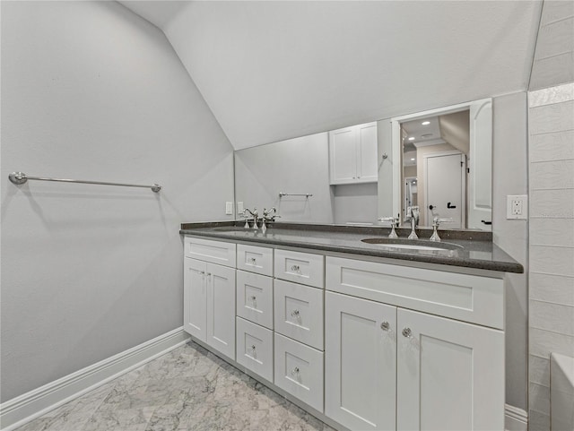 bathroom with vanity and vaulted ceiling