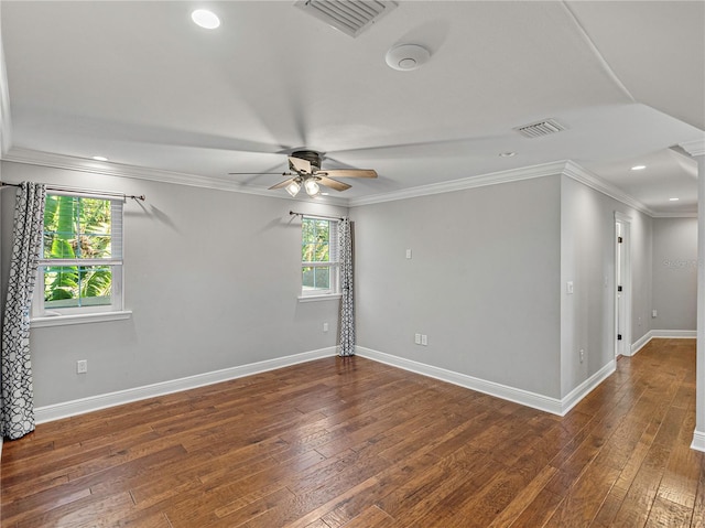 spare room with dark hardwood / wood-style flooring, ceiling fan, and crown molding