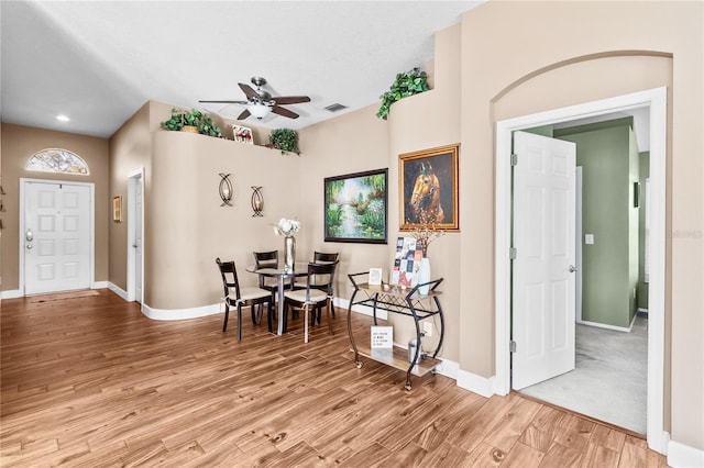 dining space with ceiling fan and light wood-type flooring