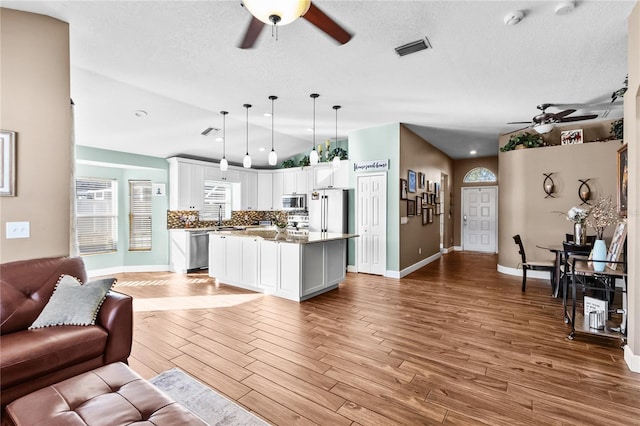 living room with light wood-type flooring and sink