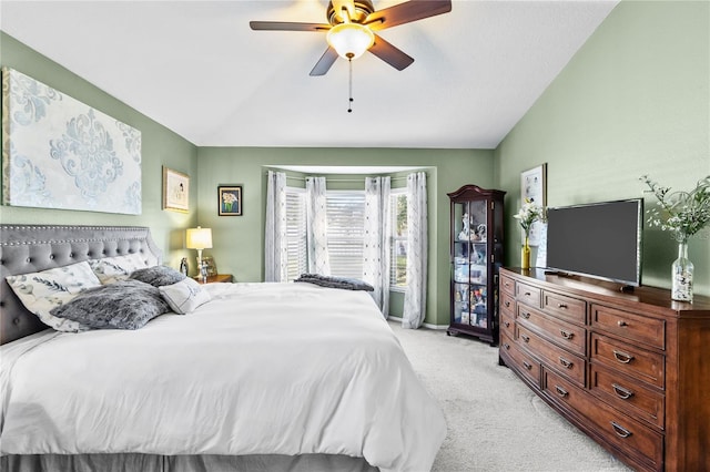 carpeted bedroom with vaulted ceiling and ceiling fan