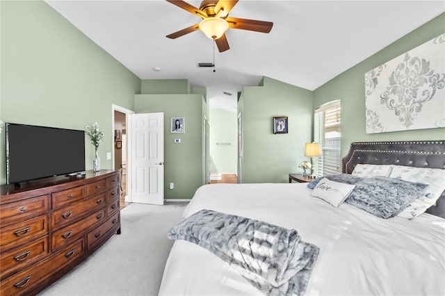 bedroom with light carpet, vaulted ceiling, ensuite bath, and ceiling fan