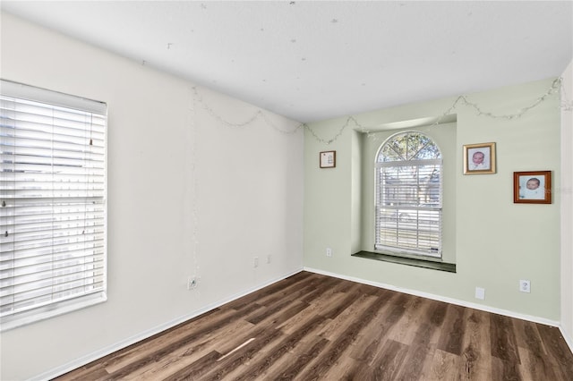 unfurnished room featuring dark hardwood / wood-style flooring