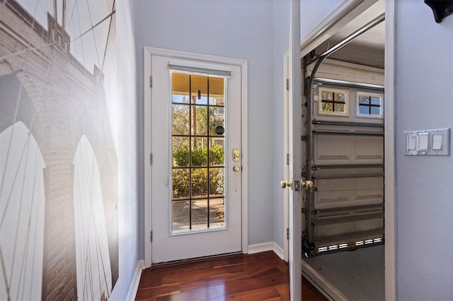 doorway to outside with dark wood-type flooring