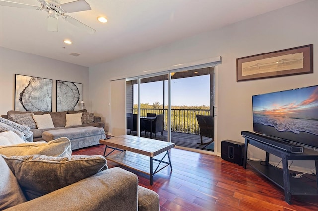 living room with ceiling fan and dark hardwood / wood-style flooring