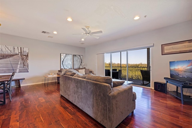 living room with dark hardwood / wood-style flooring and ceiling fan