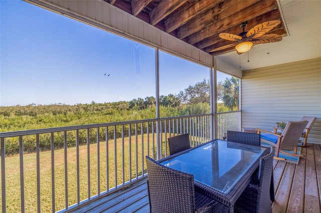 wooden deck with a yard and ceiling fan