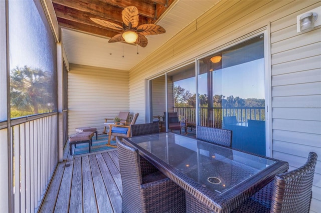 sunroom / solarium featuring ceiling fan