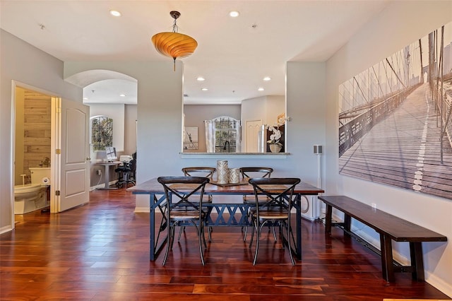 dining space with dark hardwood / wood-style flooring and plenty of natural light