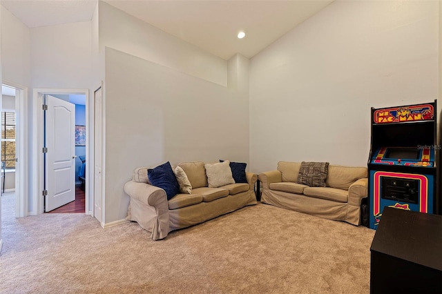 living room with carpet flooring and high vaulted ceiling