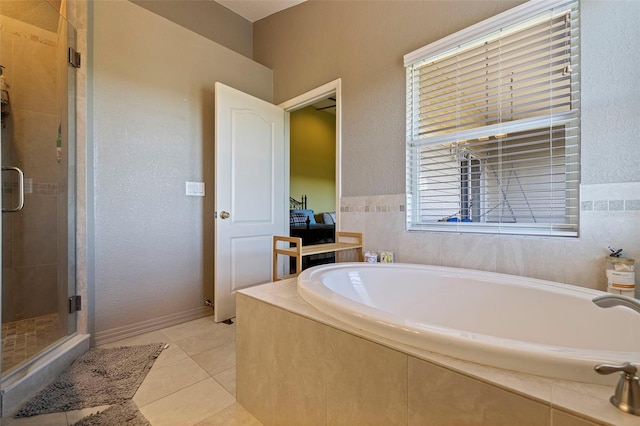 bathroom with tile patterned flooring and independent shower and bath