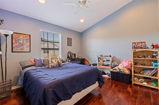 bedroom featuring ceiling fan, dark wood-type flooring, and vaulted ceiling