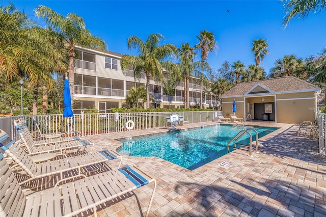 view of swimming pool featuring an outdoor structure and a patio