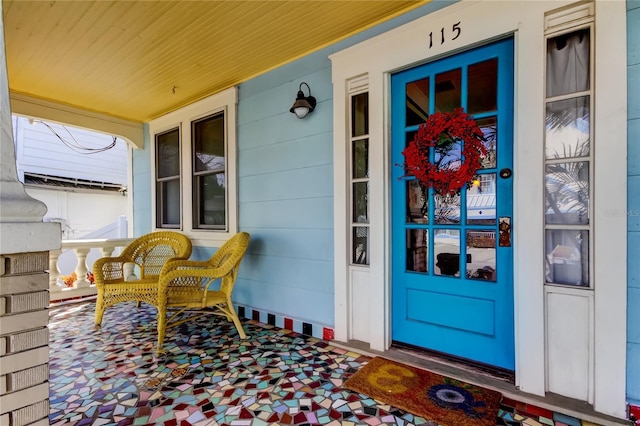 view of exterior entry featuring a porch