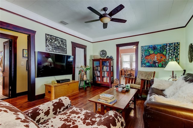 living room featuring hardwood / wood-style flooring, ceiling fan, and crown molding