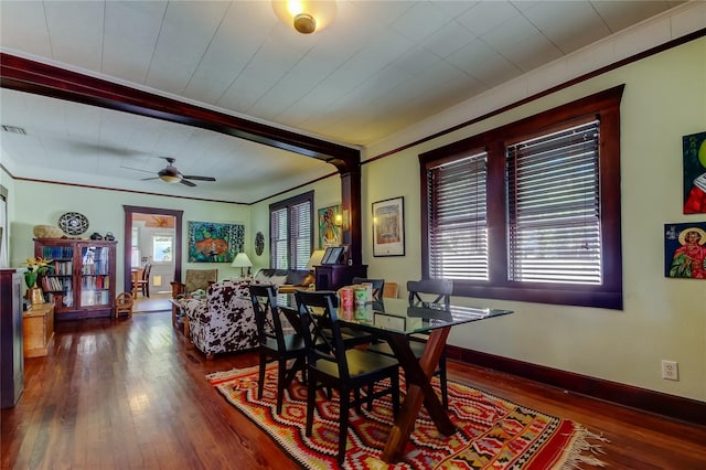 dining room featuring dark hardwood / wood-style floors, ceiling fan, and crown molding