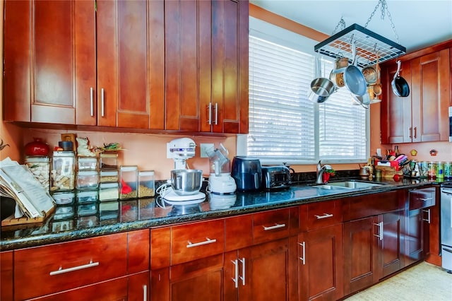 kitchen with dark stone countertops, sink, and stove