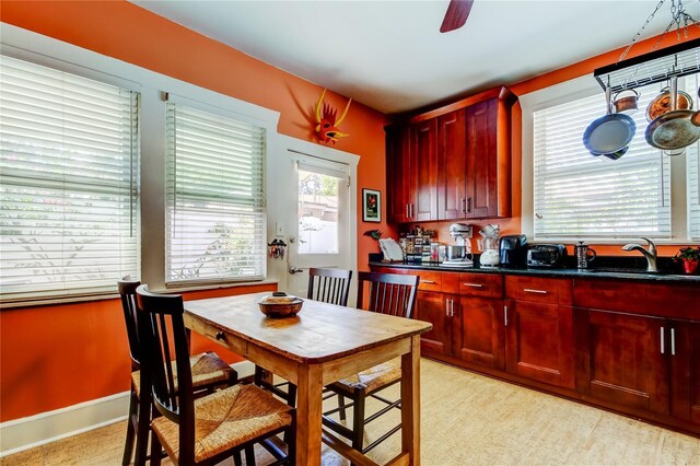 kitchen featuring ceiling fan and sink