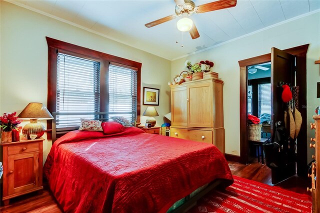 bedroom featuring ceiling fan, dark hardwood / wood-style flooring, and crown molding