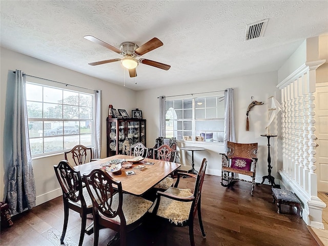 dining area featuring dark hardwood / wood-style floors, ceiling fan, and a textured ceiling