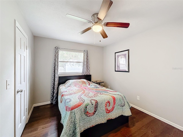 bedroom with ceiling fan and dark wood-type flooring